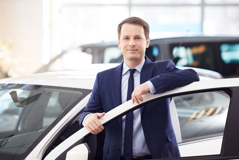 man standing by open car door