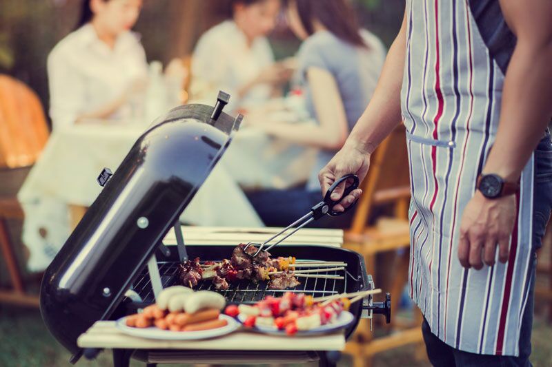 man grilling sausages